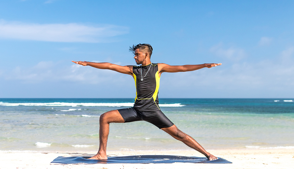 Noticias del sector Hombre haciendo yoga en la playa Columna